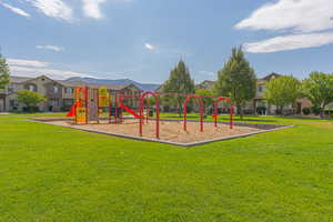 Communal playground with a residential view and a lawn