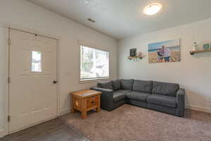 Carpeted living area with a textured ceiling