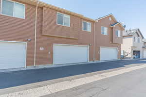 Rear view of house with a residential view and a garage