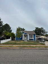 Bungalow-style house featuring a fenced front yard and an attached carport