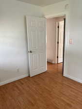 Empty room with wood finished floors and baseboards