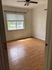 Unfurnished room with light wood-type flooring and ceiling fan
