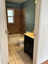 Full bath with vanity, shower / tub combination, and light tile patterned flooring