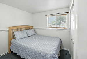 Carpeted bedroom featuring a closet