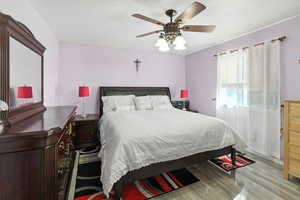 Bedroom featuring a ceiling fan and light wood-style floors