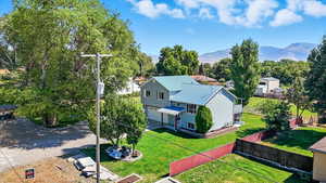 Aerial view of property and surrounding area featuring a mountain backdrop