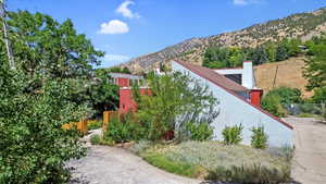 View of home's exterior with a chimney and a mountain view