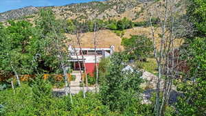 Aerial view of property and surrounding area featuring mountains