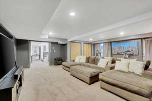theater room with light carpet, a wood stove, stairs, and recessed lighting