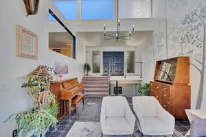 Living area with a chandelier and stairway