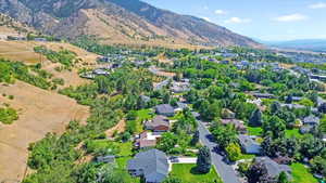 Aerial view of property's location with mountains and nearby suburban area