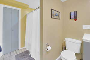Bathroom with tile patterned floors and a shower with curtain