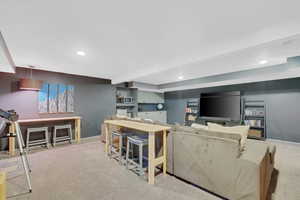 theater room with carpet flooring, recessed lighting, and beamed ceiling