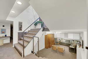 Stairs with carpet flooring, recessed lighting, and a textured ceiling