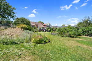 View of green lawn with a deck