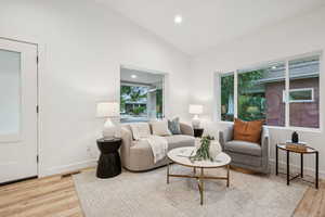 Living room featuring recessed lighting, light wood finished floors, and high vaulted ceiling
