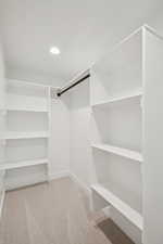 Walk in closet featuring light carpet