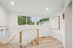 Staircase featuring recessed lighting and wood finished floors