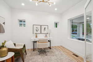 Home office featuring recessed lighting, light wood-type flooring, and a chandelier