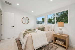 Bedroom featuring recessed lighting, light colored carpet, and lofted ceiling