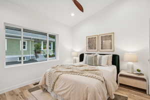 Bedroom with vaulted ceiling, light wood-style flooring, recessed lighting, and a ceiling fan