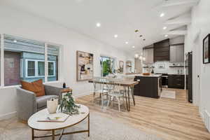 Dining room with recessed lighting, light wood-type flooring, and high vaulted ceiling