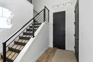 Entryway with stairway and light wood-style floors