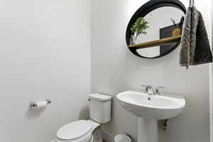 Half bath with toilet and baseboards