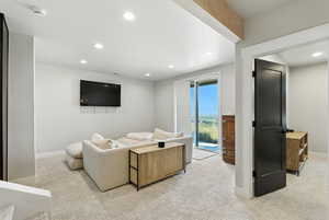 Living area featuring light carpet and recessed lighting