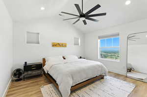 Bedroom with vaulted ceiling, light wood-type flooring, ceiling fan, and recessed lighting