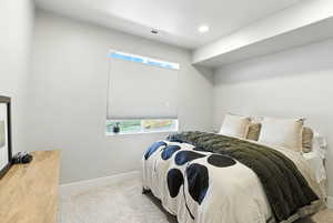 Bedroom featuring multiple windows, light carpet, and recessed lighting