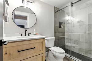 Bathroom featuring vanity and a shower stall