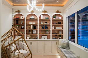 Wine room with light wood-style flooring and built in shelves