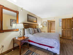 Bedroom with wood finished floors and baseboards
