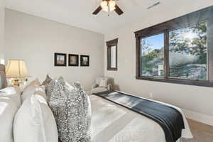 Carpeted bedroom featuring baseboards and ceiling fan
