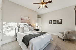Carpeted bedroom featuring baseboards and a ceiling fan