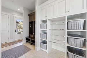 Mudroom featuring recessed lighting and light tile patterned floors