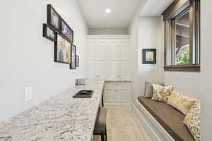 Mudroom with light tile patterned floors and recessed lighting