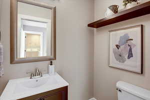 Half bathroom with vanity and toilet