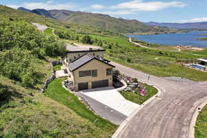 View from above of property with a water and mountain view