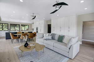 Living room with recessed lighting and light wood-type flooring