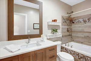 Full bathroom with tiled shower / bath and vanity