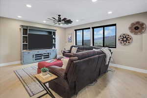 Living area featuring light wood-style flooring, recessed lighting, and ceiling fan