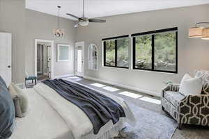 Bedroom with high vaulted ceiling, carpet, a chandelier, and ceiling fan