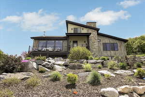 Back of house featuring a chimney