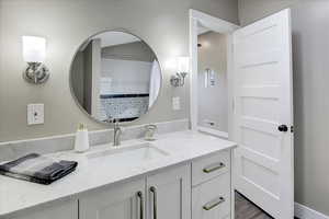 Bathroom featuring vanity, a shower with curtain, and dark wood-style flooring
