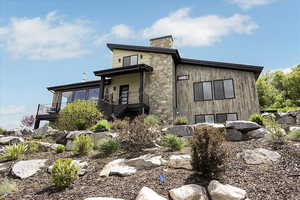 View of side of property featuring a chimney and stairway