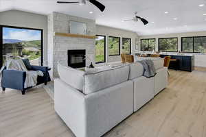 Living area featuring plenty of natural light, vaulted ceiling, a ceiling fan, and recessed lighting