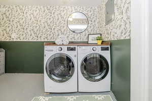Laundry room featuring washer and dryer and electric panel