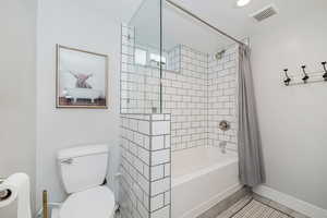 Full bath featuring shower / bath combination with curtain and recessed lighting